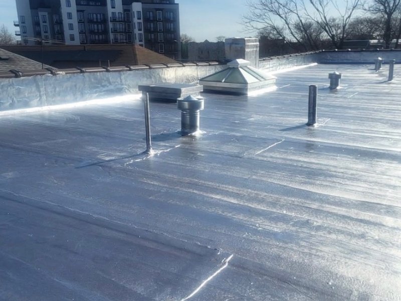Flat roofing Services. Torch down roofing with silver coating for asthetics