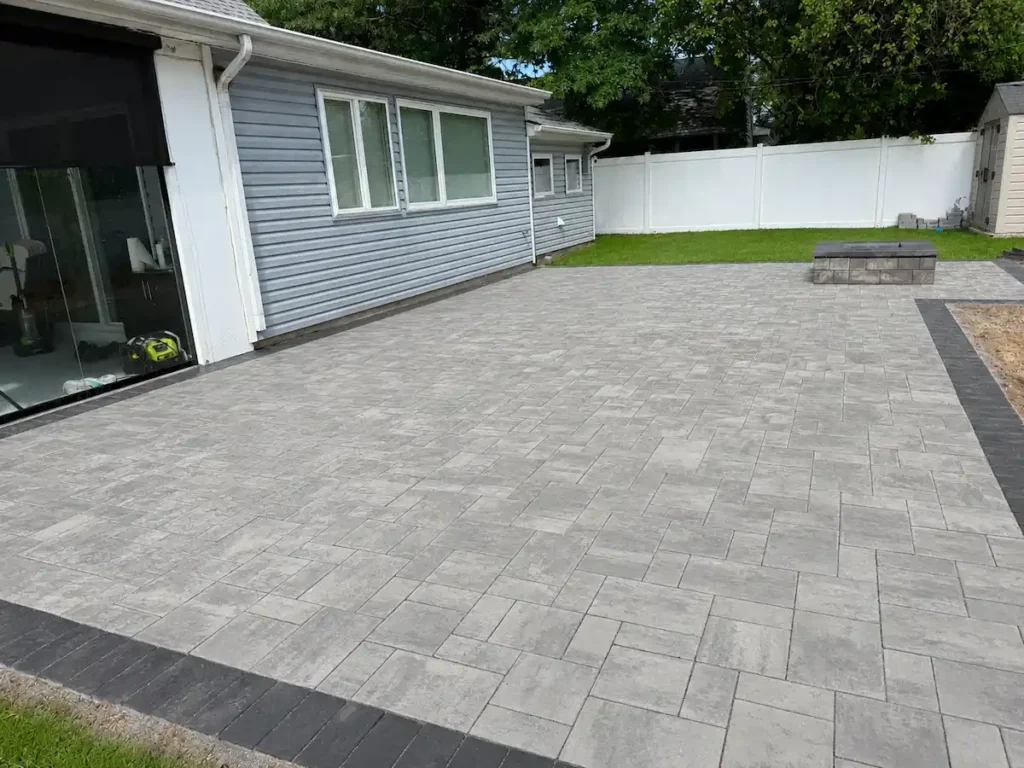 Large masonry patio with gray pavers and contrasting border